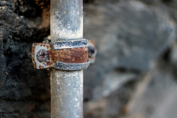 Rusted water or electrical pipe on the wall