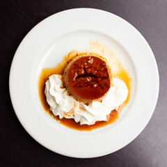 Sweet dessert, flan with caramel sauce and whipped cream