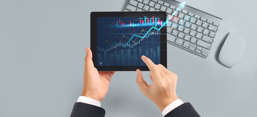 Business plan graph growth  increase of chart positive indicators in his business,tablet in hand
