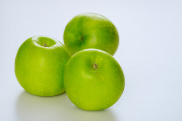 Whole green apples and isolated on white background.