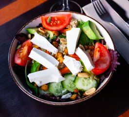 Delicious quinoa salad with tomato, avocado, cucumber, lettuce and fresh cheese