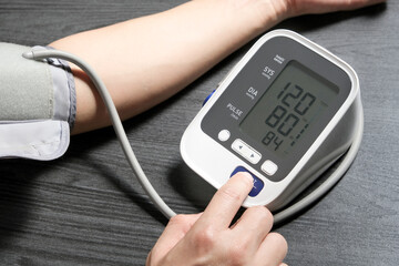 Man check blood pressure monitor and heart rate monitor with digital pressure gauge. Health care and Medical concept