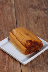 A slice of bread on a white plate.