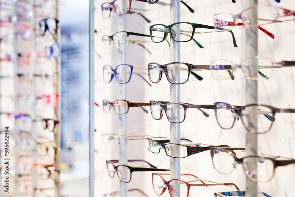 Poster image of glasses showcase at modern optic shop, nobody