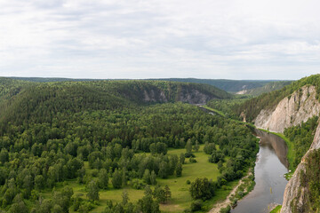 Summer green valley river mountain  landscape. Winding river with overgrown banks, top view. Aerial shot of nature