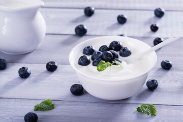 yogurt and blueberry on white wooden table. Healthy аnd tasty  breakfast