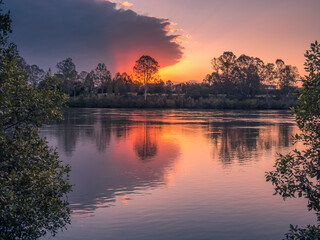 Naklejka na ściany i meble Beautiful Riverside Sunset with Reflections
