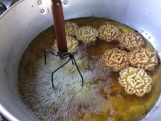 Dok Jok Thai dessert Crispy Lotus Blossom Cookie Fried with oil in a pan