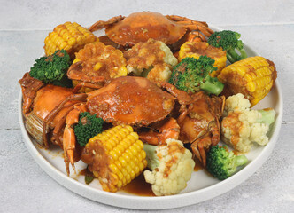 Kepiting saus padang or Padang sauce crab is an Indonesian seafood dish consisting of crabs, corn, broccoli and cauliflower served with hot and spicy Padang sauce.