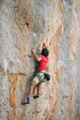 A climber is training on a natural terrain.