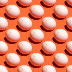 Seamless pattern with boiled egg on orange background.