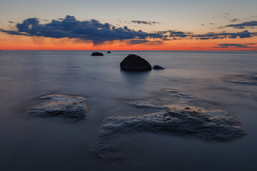 Fototapeta na wymiar Late summer sunset on shore of the Baltic Sea , rocky coast. Estonia.