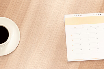 Top view half coffee and calendar with copy space center 