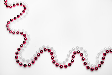 Red and white beads on a white background: place for text, Valentine's day or cardiology, healthy heart