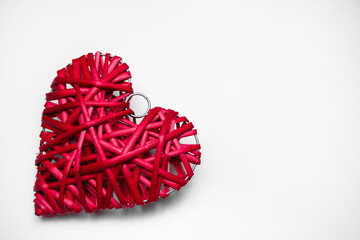 Big red wicker heart on a white background: place for text, Valentine's day or cardiology, healthy heart