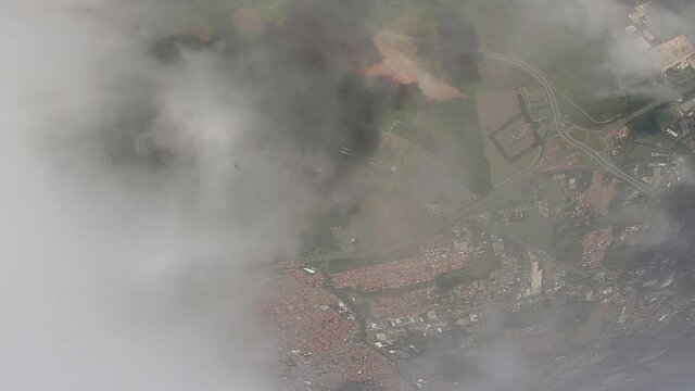Parachutist's point of view when crossing the clouds and seeing his own shadow.