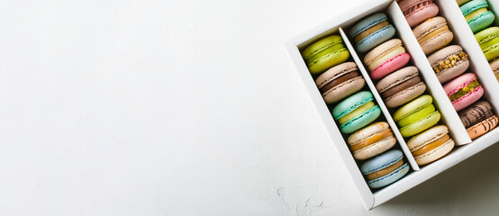 Colourful french macaroons on white background. Top view. Banner for website, design