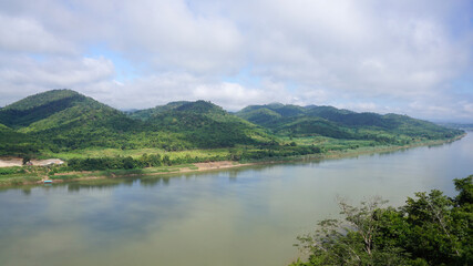 Naklejka na ściany i meble Green Mountain range and Khlong river at the border of Laos from the view point of Chaing Kkhan skywalk, Loei Province , Thailand 