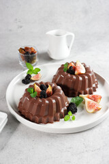 Puding Coklat. Chocolate puddings are a class of desserts with chocolate flavors, garnish with blackberry and figs.