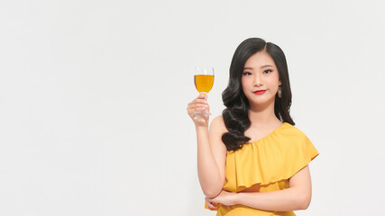 Young happy woman in yellow dress looking away and smiling with champagne isolated