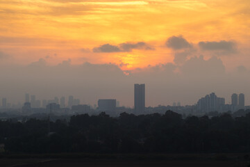 A silhouette of the buildings of Tel Aviv against the backdrop of the setting sun