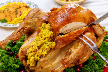 Cut roasted whole turkey for Christmas dinner.