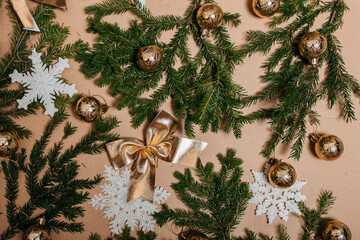 Christmas decorations flat layout with many fir branches on the cardboard background. Eco-friendly christmas ornaments. Scandinavian christmas cards with fir branches and snowflakes.