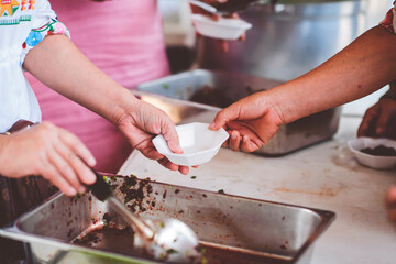 concept of charity food for the poor: Volunteers give food to the poor