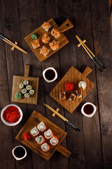Appetizing rolls on a wooden background. Japanese food concept. Close-up. Copy space. Flat lay.