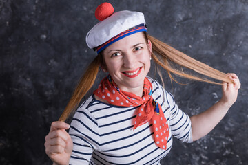 Beautiful midle aged lady having fun in sailor's suit
