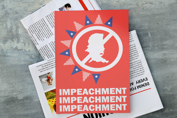Newspapers and book on table. Concept of impeachment