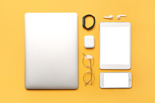 Modern gadgets on color background