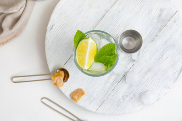 Glass of fresh mojito on table