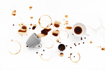 Overturned cup and spilled coffee on white background