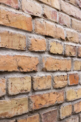 A wall of old yellow and brown bricks.