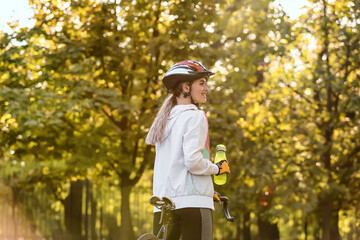 Female cyclist riding bicycle outdoors