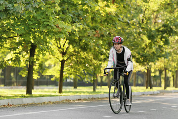 Fototapeta premium Female cyclist riding bicycle outdoors