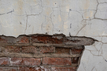 brick wall texture of old red brickwork and cracked white plaster