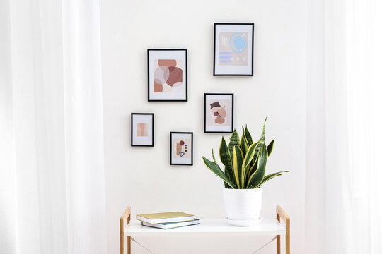 Table near wall with beautiful pictures