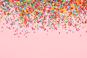 Sweet sprinkles on color background