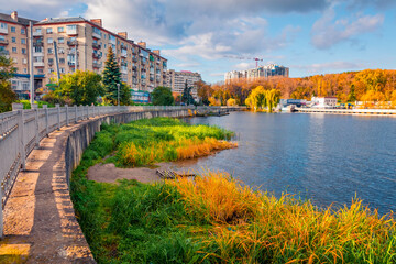 Fototapeta na wymiar Vivid autumn cityscape of Ternopil town, West Ukraine, Europe. Stunning morning scene of city park with fishing lake. Traveling concept background..
