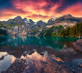Dramatic summer sunrise on the unique Oeschinensee Lake. Splendid morning scene in the Swiss Alps...