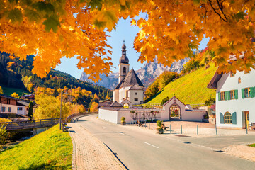 Beautiful autumn scenery. Fabulous morning scene of Parish Church of St. Sebastian. Colorful autumn...