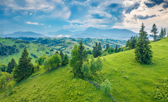 Fresh green view from flying drone of green valley in Carpathian village Stebnyi. Dramatic summer scene of Transcarpathian region, Ukraine, Europe. Traveling concept background.