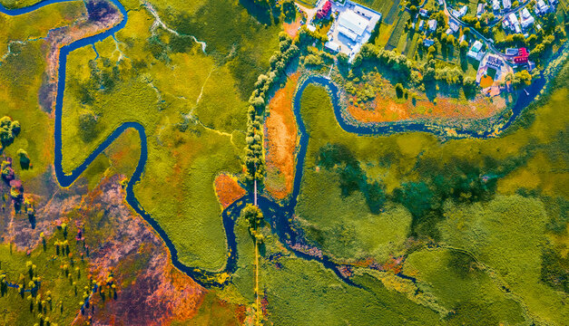Straight dawn panoramic view from flying drone of bridge over Seret river, Ternopil region, Ukraine, Europe. Spectacular summer scene of green flooded valley. Beauty of nature concept background.