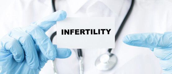 Doctor holding a card with text infertility, Medical concept