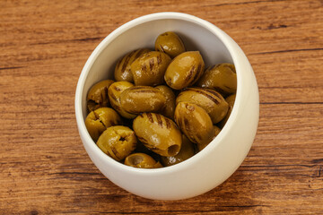 Green grilled olives in the bowl