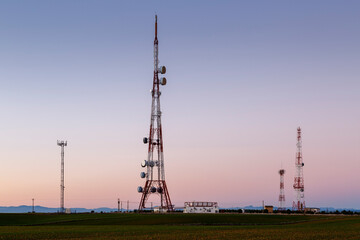 Sunset landscape with television signal repeater metal towers. Telecommunications. Matadeón de Los Oteros, León, Spain.
