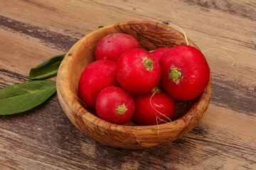 Ripe fresh radish heap over wooden