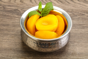 Sweet ripe canned peaches with mint